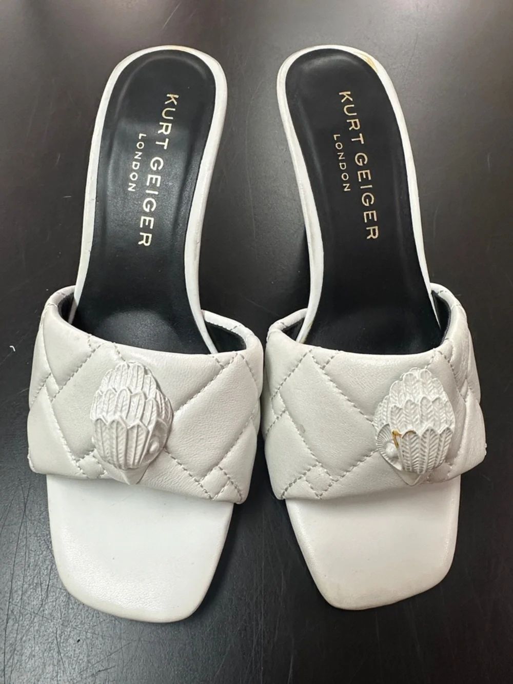 Kurt Geiger White Quilted Leather Slide Mules with Sculpted Medallion
